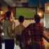 Group of men standing at a bar watching a large TV screen showing a soccer game in a dimly lit pub.