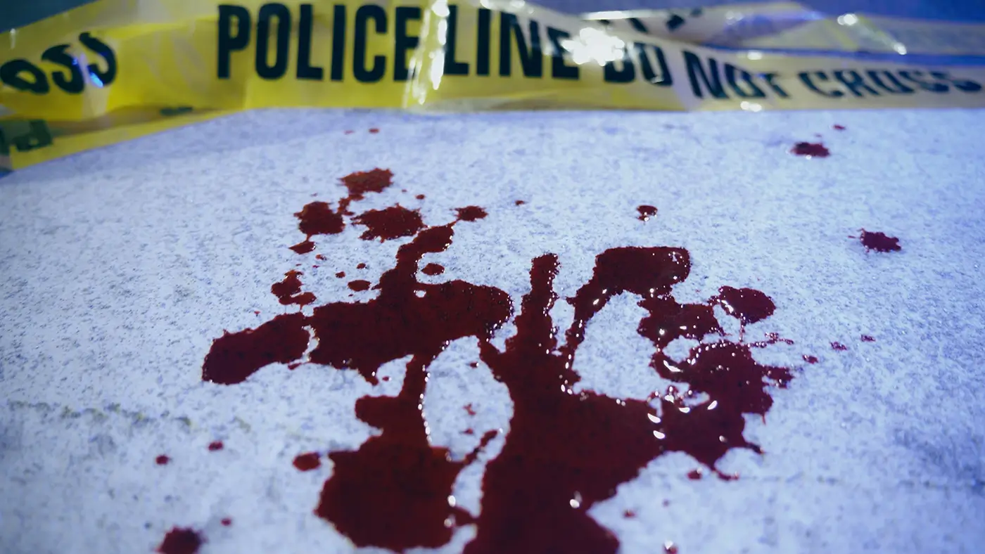 Na podlaze je čerstvá krev a za ní žlutá policejní páska