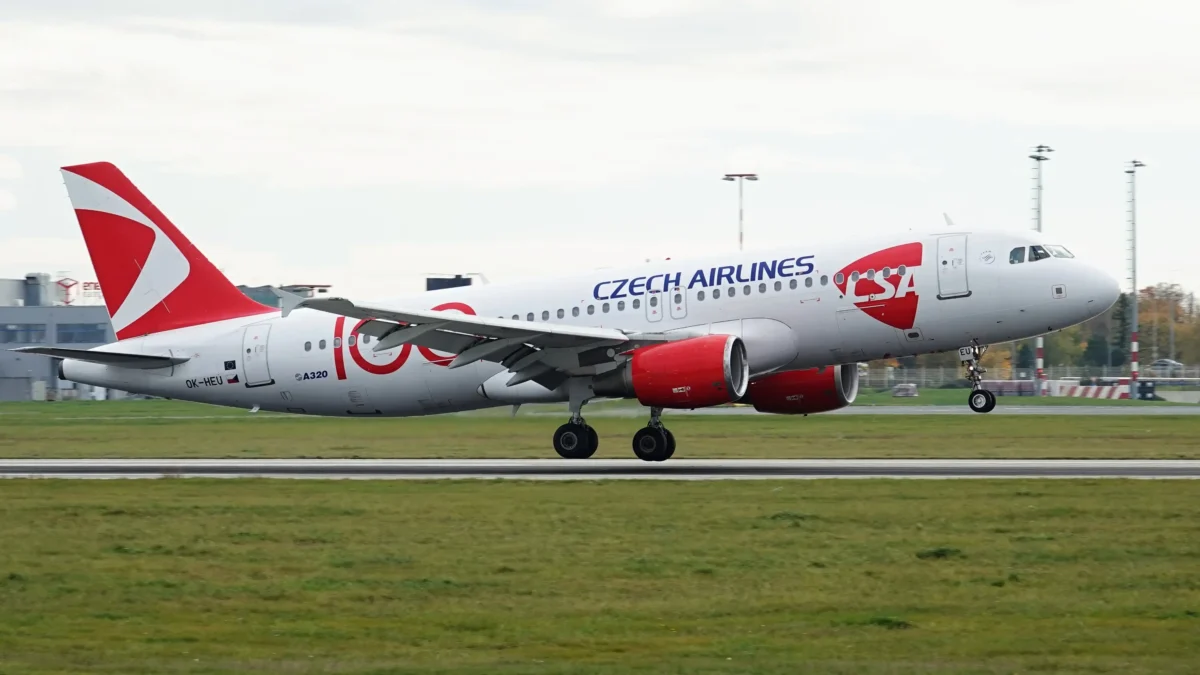 Airbus A320 Českých aerolinií pojíždějící po ranveji s červeným ocasem a viditelným logem ČSA