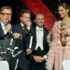 Václav Kopta s mikrofonem stojí vedle tří lidí.