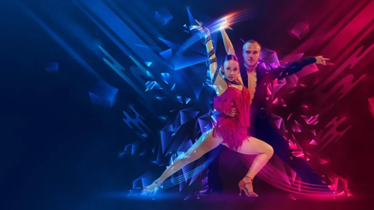 Duo of ballroom dancers mid-leap on a neon-lit stage, woman in a pink fringe dress and man in dark attire, with blue and magenta geometric light effects.