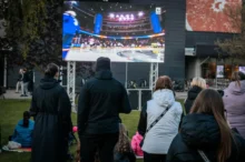 fanoušci sledují sportovní přenos venku