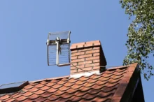 Na střeše za komínem je televizní anténa k chytání televizního signálu