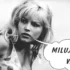 Black-and-white photo of a blonde woman with a speech bubble that says 'MILUJI VÁS'.