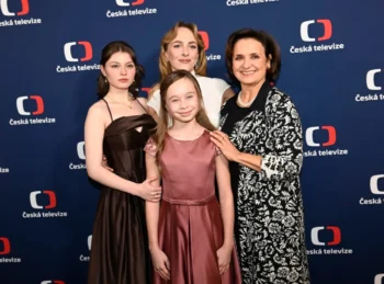 Four people in formal attire posing on a Česká televize backdrop.