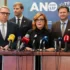 žena s brýlemi u pultu s mikrofony