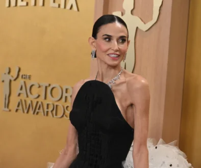 Demi Moore se dívá do strany a usmívá se.